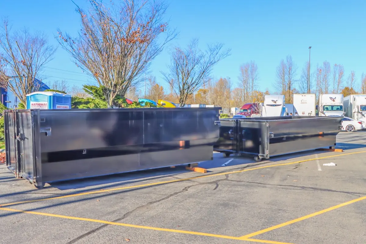 Professional dumpster rental service with roll-off container on residential driveway in Menomonee Falls